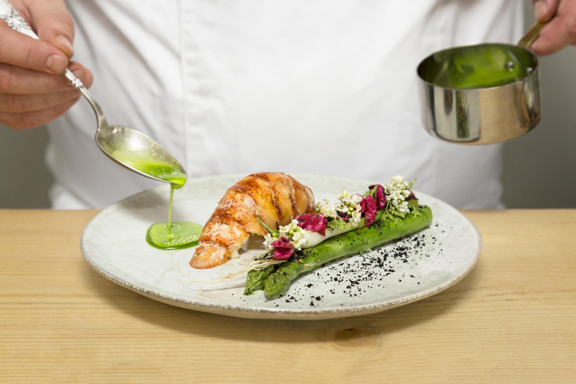 Chef forming a colorful plated dish